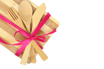 Cooking background - cutlery on cutting board tied with ribbon