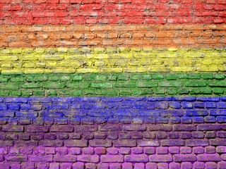 Fototapeta premium Rainbow-flag painted on old wall