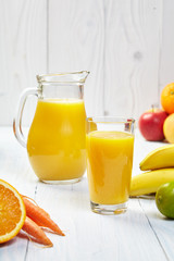 Glasses with fresh vegetable juices isolated on white table. Det
