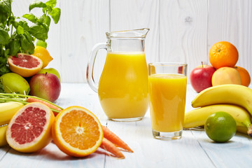 Glasses with fresh vegetable juices isolated on white table. Det