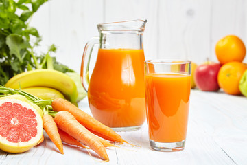 carrot juice on white wood  background