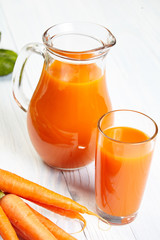 carrot juice on white wood  background