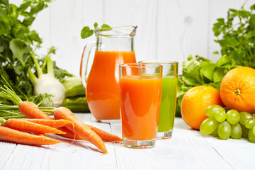 carrot juice on white wood  background