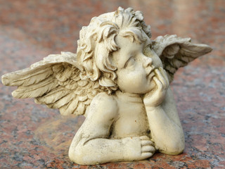 decorative sculpture of putto isolated on granite surface