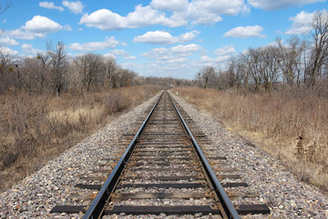 Railway to horizon and clouds on the sky background.