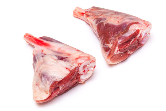 Goat meat shanks isolated on a white studio background.