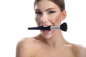Beauty portrait of a woman on a white background with a brush