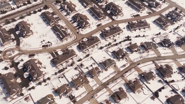 Aerial Of Homes In A Snow Covered Suburban Neighborhood