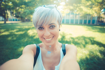 young beautiful short blue hair hipster woman selfie