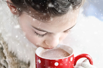 Young girl drinking hot chocolate outdoor