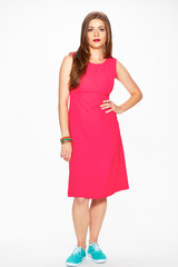 Fashion photo of young model in red dress.