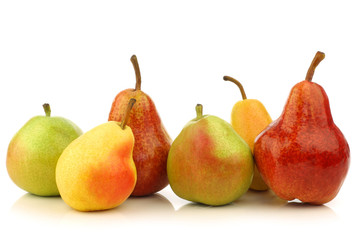 Assortment of different colorful pears on a white background