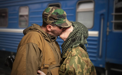 Romantic scene of farewell of wife with husband leaving on milit