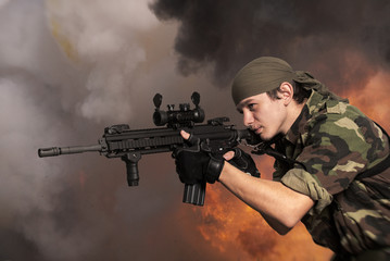 Portrait of the soldier with an automatic assault rifle