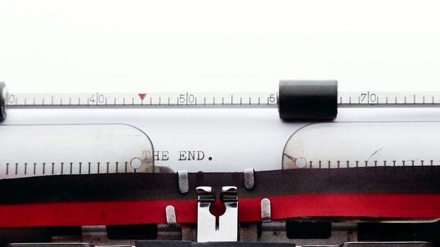 The end written on an old typewriter, story writer concept