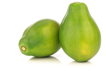 two fresh papaya fruits on a white background
