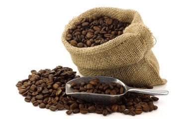 coffee beans in a burlap bag on a white background © tpzijl