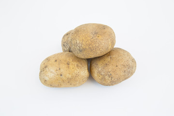 Raw old potatoes isolated on white background