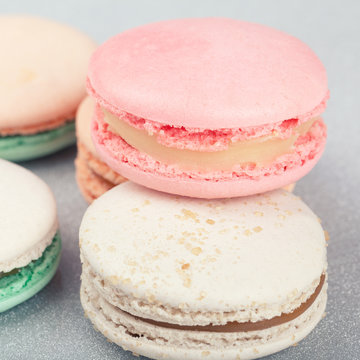 Traditional French sweets Macarons on shiny grey background