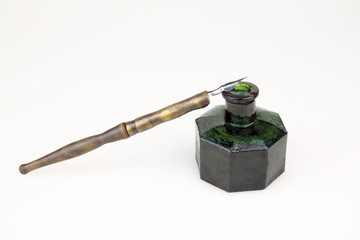 vintage ink pen and old glass inkwell isolated