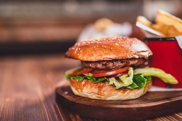 Fresh burger on wooden table.