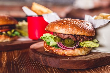 Fresh burger on wooden table.