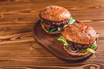 Fresh burger on wooden table.