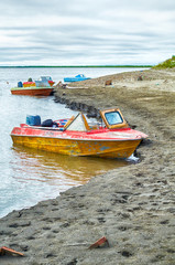 Old motor boats on the bank of river Indigirka  in north yakutia