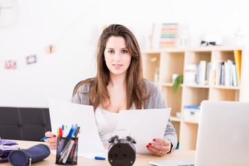 Beautiful young woman working and studying at home