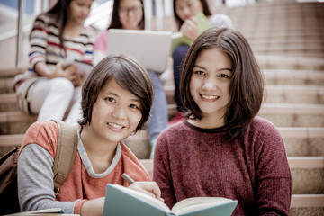attractive female college student sitting on stairs
