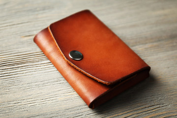 Hand made leather man wallet on wooden background