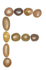 collection of letters of sea stones close-up isolated on white b