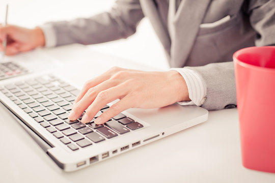 Closeup of businessman hands typing on laptop computer