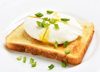 Poached egg on bread over white plat