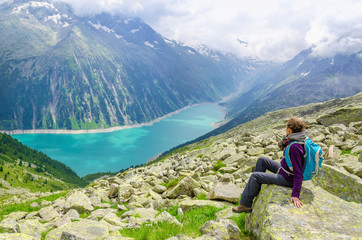 Naklejka premium Beautiful alpine landscape, young woman and azure mountain lake