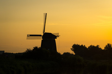 dutch windmill silhouette during sunset near amsterdam - Netherl