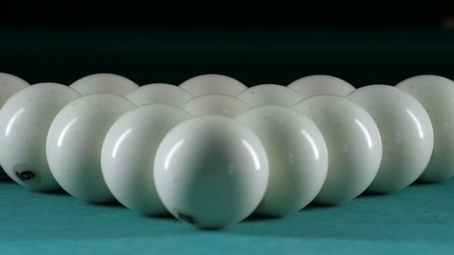 Triangle forms a pyramid of billiard balls. Close up. Slow
