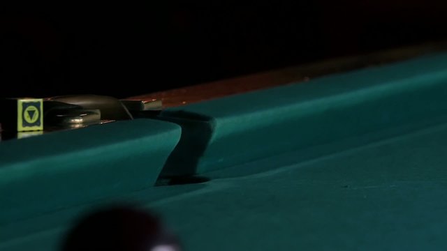 White ball falls into a pocket billiard after impact. Slow