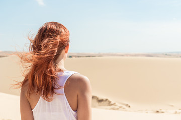 Fototapeta na wymiar Beautiful woman in sand dunes