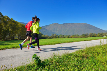 Young couple jogging in park at morning. Health and fitness.