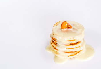 isolated stack of pancake with condensed milk and nuts