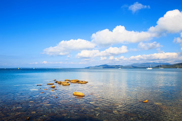 Rocks and yachts in a sea bay. Punta Ala, Tuscany, Italy