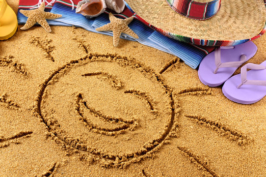 Mexico smiling beach sun drawing in sand with sombrero photo