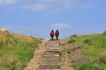 Women climbing up a wooden ladder