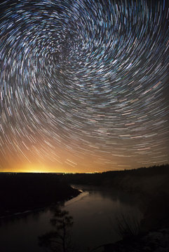 beautiful night sky, spiral star trails and the forest