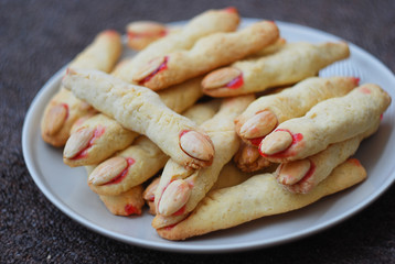 Fototapeta na wymiar Plate with cookies in witch fingers form