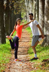 Young couple jogging in park at morning. Health and fitness.