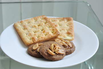 Cookie and bread on white plate
