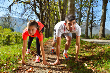 Young couple jogging in park at morning. Health and fitness.