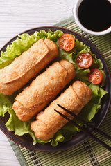 spring rolls fried on lettuce close-up, vertical top view